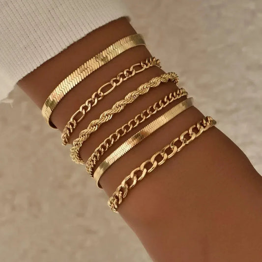 Set of gold bracelets with different chain styles