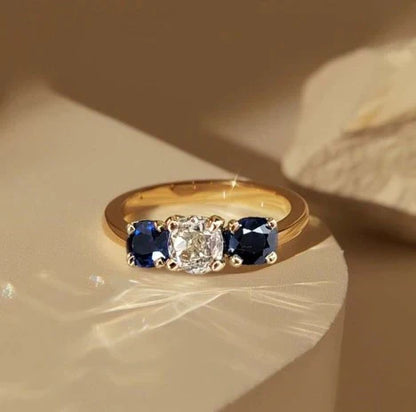1+1 Offer: Golden Three Stone Cushion Cut White & Blue Sapphire Wedding Band Ring for Women + Round Cut White Sapphire Gold Necklace